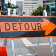 A detour sign on a street