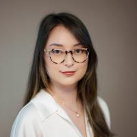 A woman with long brown hair and glasses